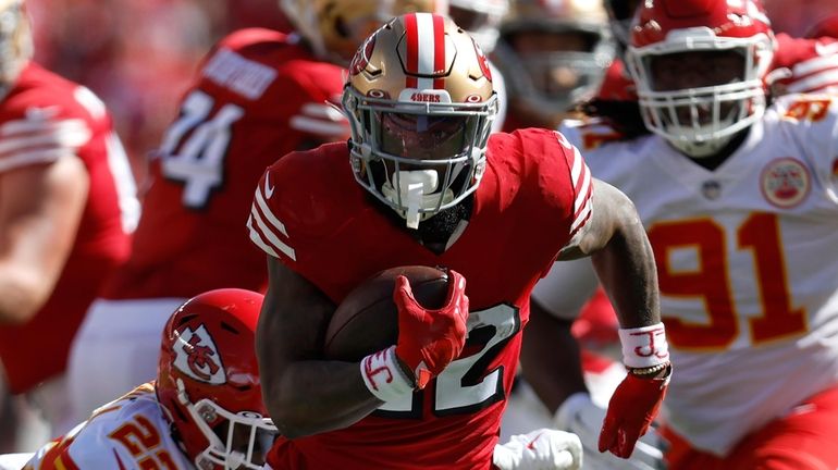 San Francisco 49ers running back Jeff Wilson Jr. runs against...