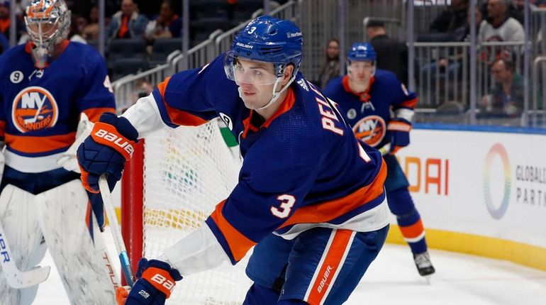 Adam Pelech #3 of the Islanders plays the puck during...