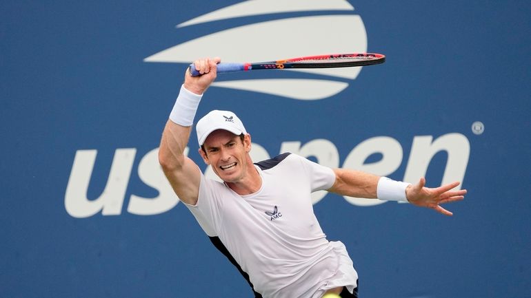 Andy Murray, of Britain, returns a shot to Corentin, Moutet,...