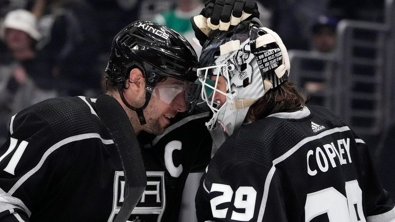 Los Angeles Kings center Anze Kopitar (11) celebrates with goaltender...