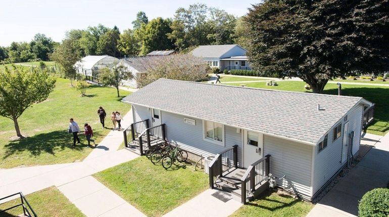 Students walk back to the main school building from a...