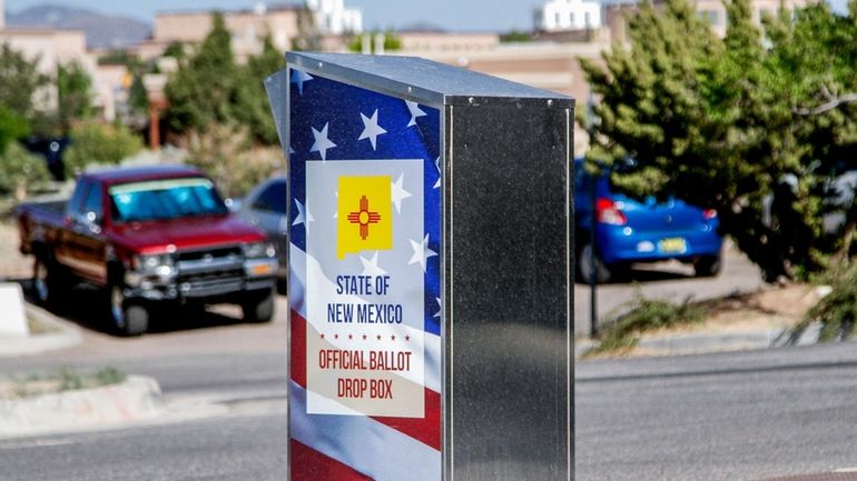 A ballot drop box awaits deposits at an early voting...