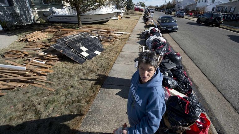 Freeport resident Eileen Maher standing at the curb outside her...