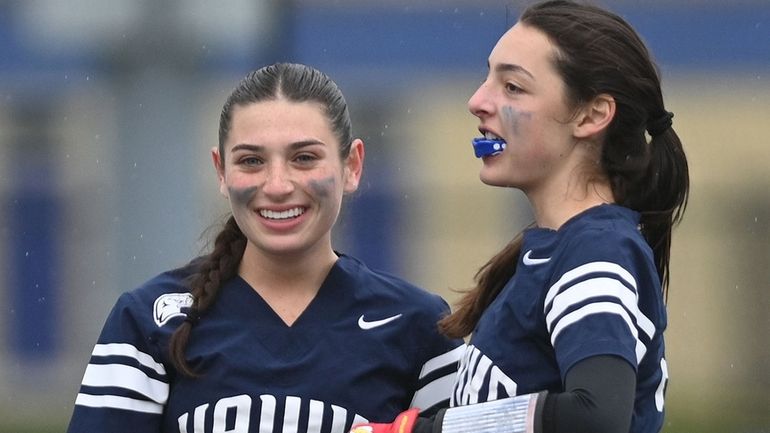 Gabi Weinstein, left, and Plainview-Old Bethpage JFK teammate Lara Glasser  react...