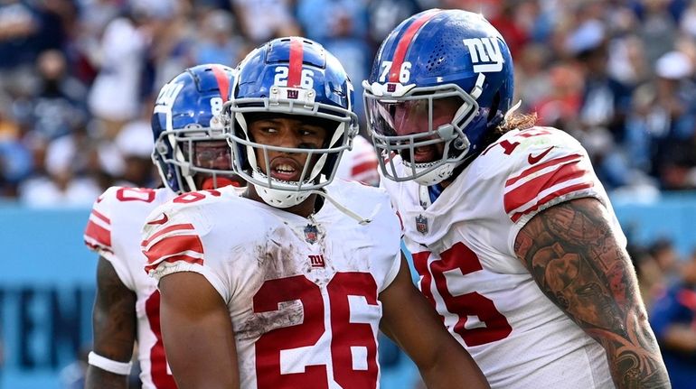 Giants running back Saquon Barkley celebrates after scoring a touchdown against...