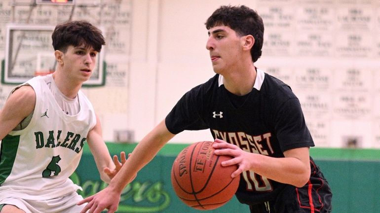 Dylan Eisenberg of Syosset works to the basket in a Nassau...