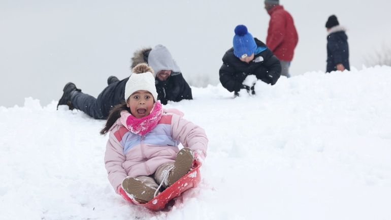 Olivia Dilone, 7, of Freeport, with her dad Joel Dilone,...