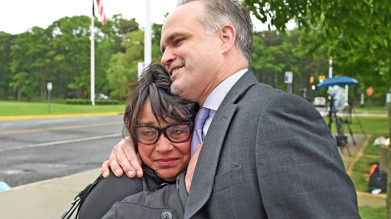 Linda Mangano, embraces her attorney John Carman, outside federal court...