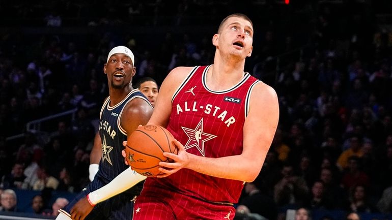 Denver Nuggets center Nikola Jokic (15) goes up for a...