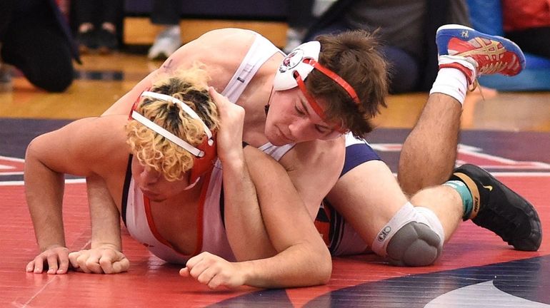 Greyson Meak of Cold Spring Harbor, top, battles Kenneth Aristondo...