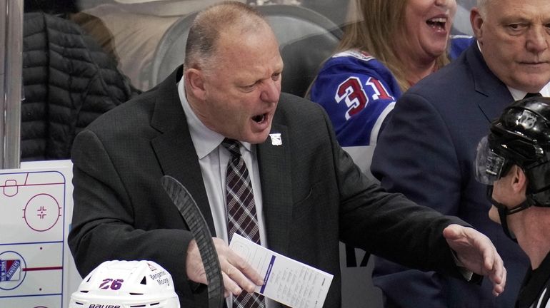 Rangers head coach Gerard Gallant, top left, talks with referee...