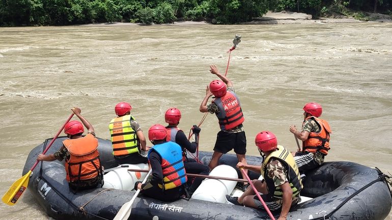 Nepal army personnel cary out a search operation looking for...