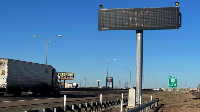 A truck passes a warning sign about the Smokehouse Creek...