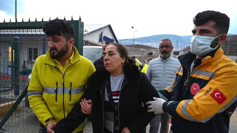 Relatives of missing miners leave the Copler gold mine near...