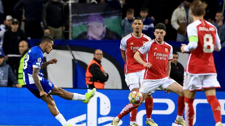 Porto's Galeno, left, scores the opening goal during a Champions...