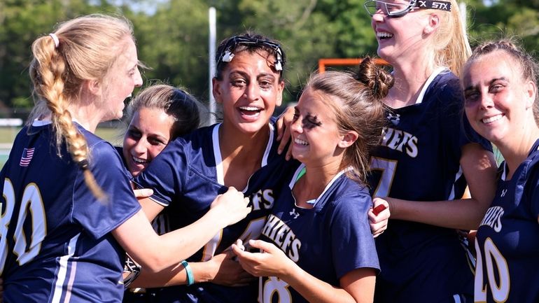 Massapequa midfield Isabella Grosso (middle) celebrates with her teammates, after...