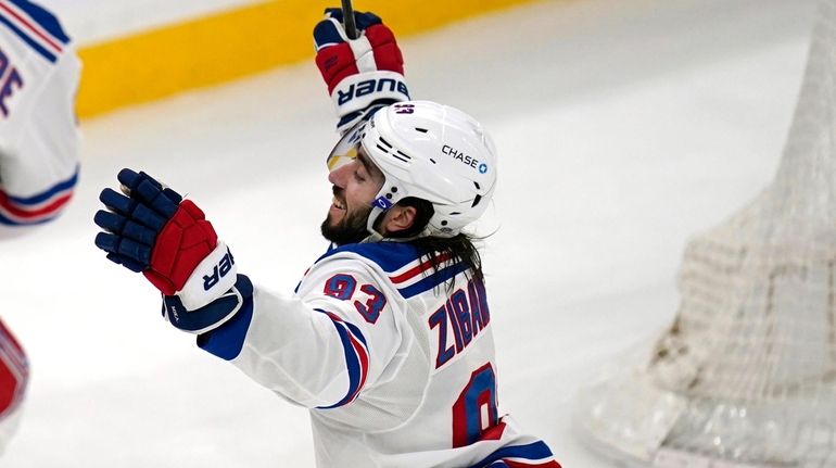 Rangers center Mika Zibanejad (93) raises his arms after scoring...