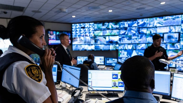 Security Inspector Malinda Mccormack speaks on the phone during a...