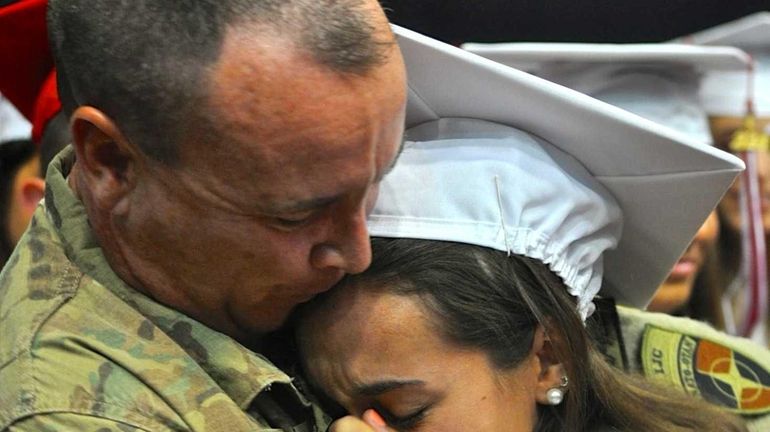 Army Lt. Col. Richard Davis reunites with his daughter, Stephanie,...