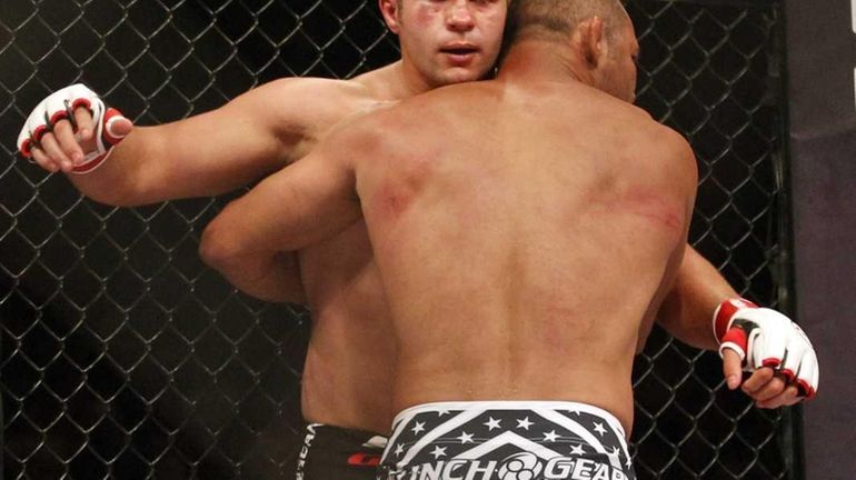 Fedor Emelianenko, left, tries to hit Dan Henderson, right, during...