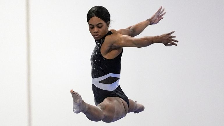 Gabby Douglas competes on the balance beam at the American...