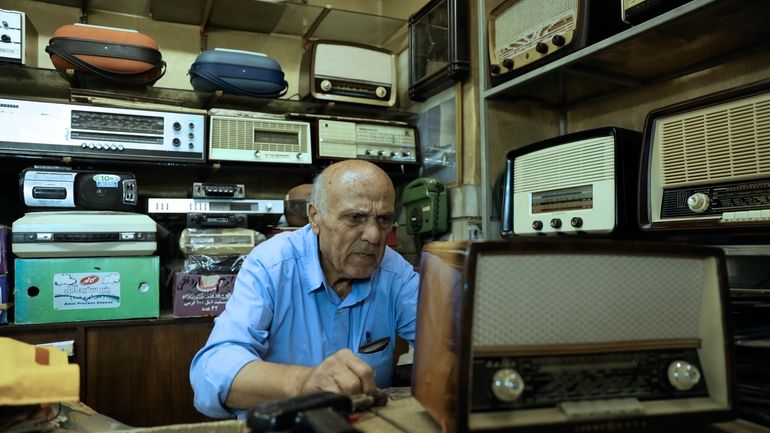 Reza Alimirzaei, 73, who repairs and sells old radios, works...