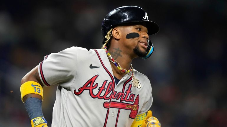 Atlanta Braves' Ronald Acuna Jr. runs after hitting a single...