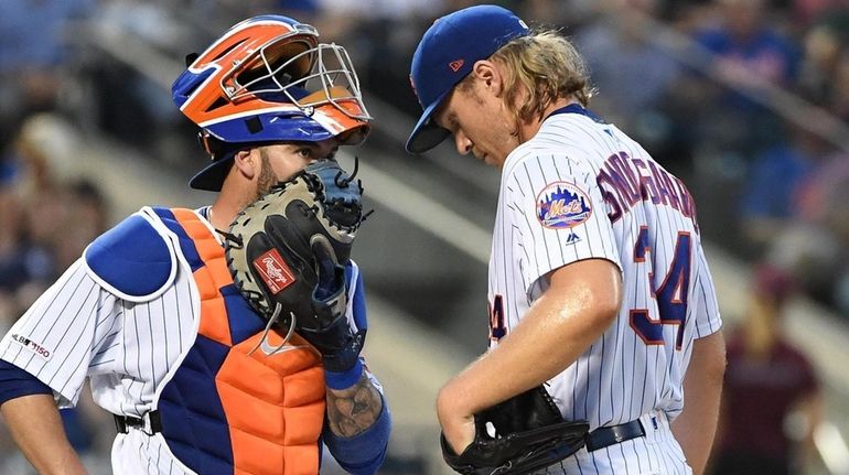 Mets catcher Tomas Nido and starting pitcher Noah Syndergaard talk...