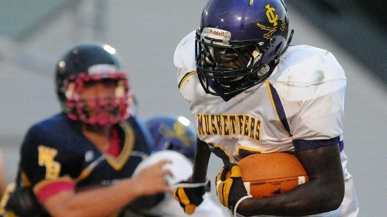 Central Islip's Kevin Mowatt runs for a gain during the...