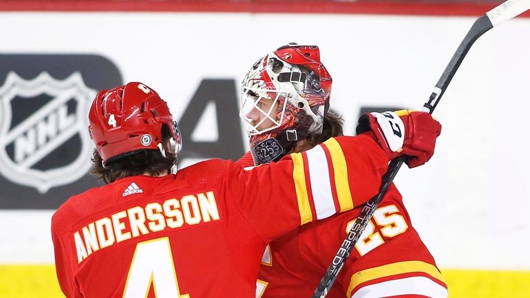 Calgary Flames goalie Jacob Markstrom and teammate Rasmus Andersson celebrate...