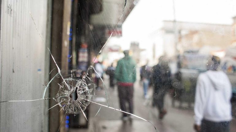 A bullet hole can be seen through the front door...