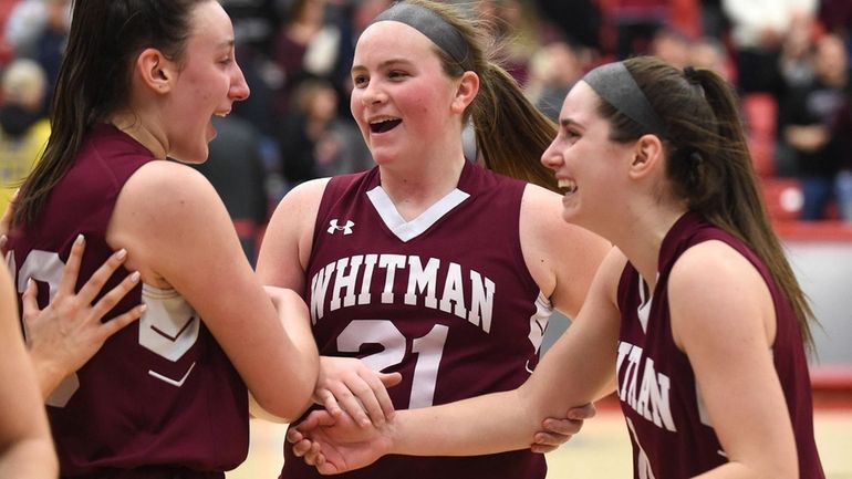 Iris Hoffman #21 of Whitman, center, celebrates with teammates Brianna...