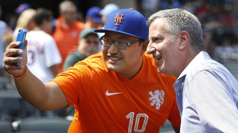 A New York Mets and soccer fan takes a photo...