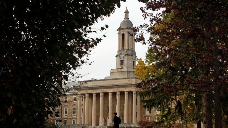 FILE- In this Nov. 9, 2017, file photo people walk...