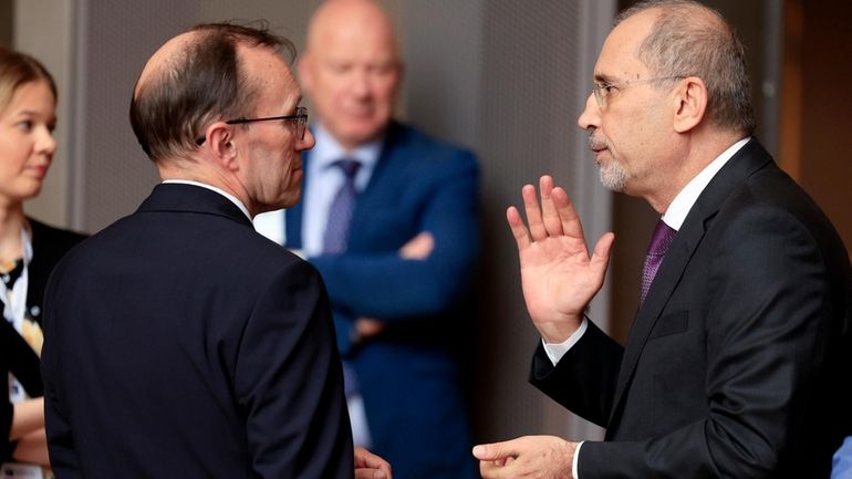 Norway's Foreign Minister Espen Barth Eide, left, speaks with Jordan's...