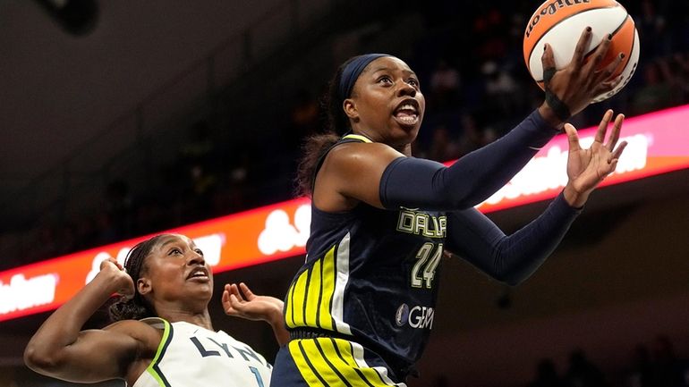 Dallas Wings guard Arike Ogunbowale (24) shoots next to Minnesota...