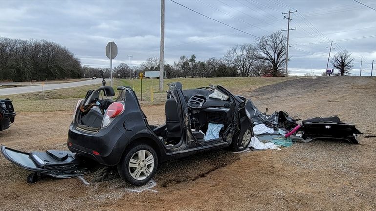 In this image provided by KFOR-TV, a heavily damaged vehicle...