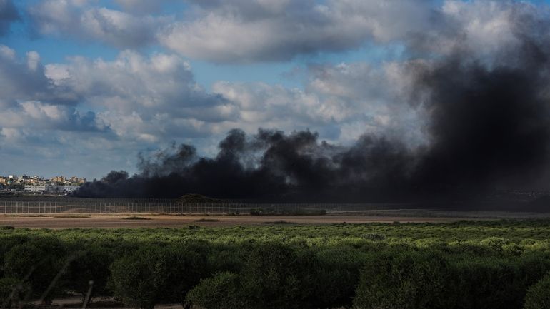 Smoke rises from tires set ablaze by Palestinian demonstrators during...