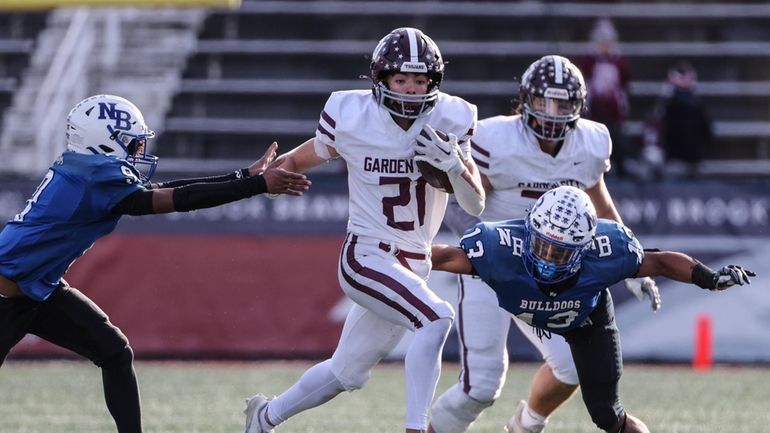 Blake Cascadden of Garden City gets past two North Babylon...