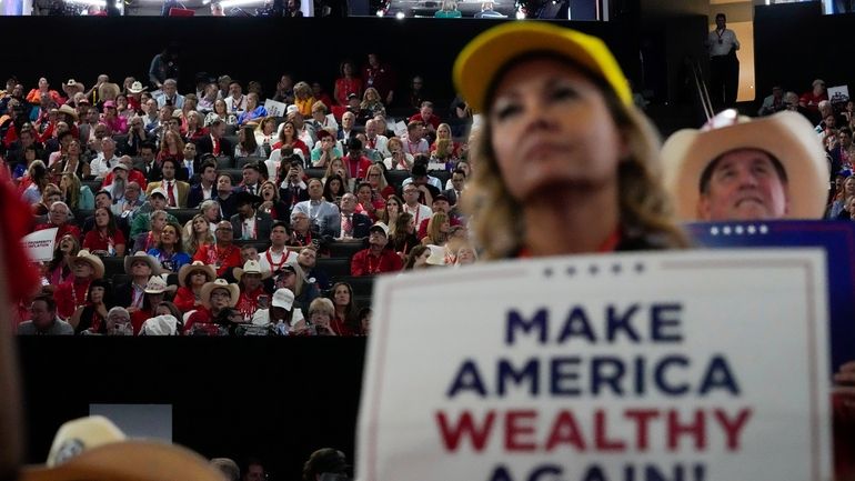 Delegates watch during the Republican National Convention Monday, July 15,...