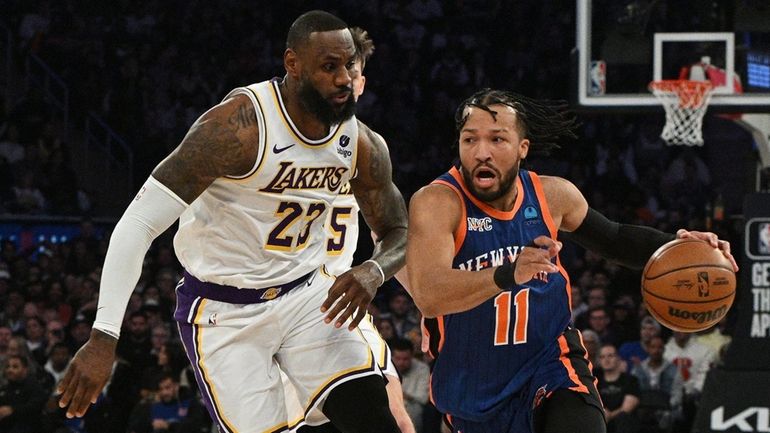   Knicks guard Jalen Brunson drives past Lakers forward LeBron...