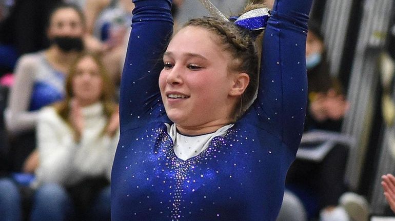 Shani Sirota of Roslyn concludes her balance beam routine during...