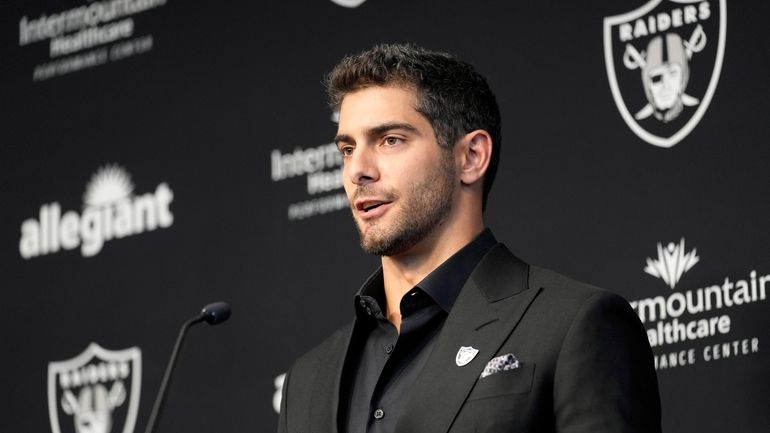 Las Vegas Raiders quarterback Jimmy Garoppolo takes questions at a,...