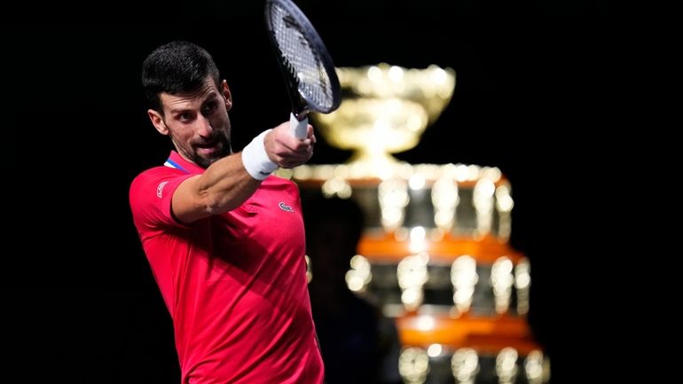 Serbia's Novak Djokovic reacts, with the Davis Cup on the...