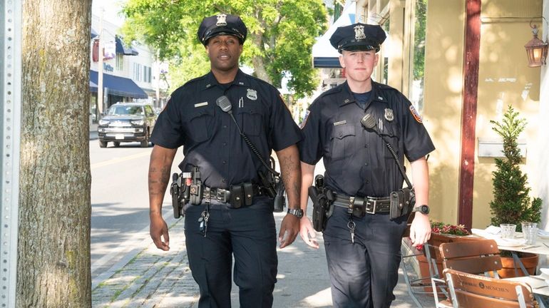 Officers Ryan Creighton, left, and John Locke patrol Front Steet...