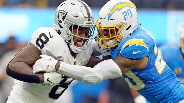 Las Vegas Raiders running back Josh Jacobs (28) gains yards on a run during  an NFL football game against the Los Angeles Chargers, Sunday, September  11, 2022 in Inglewood, Calif. The Chargers