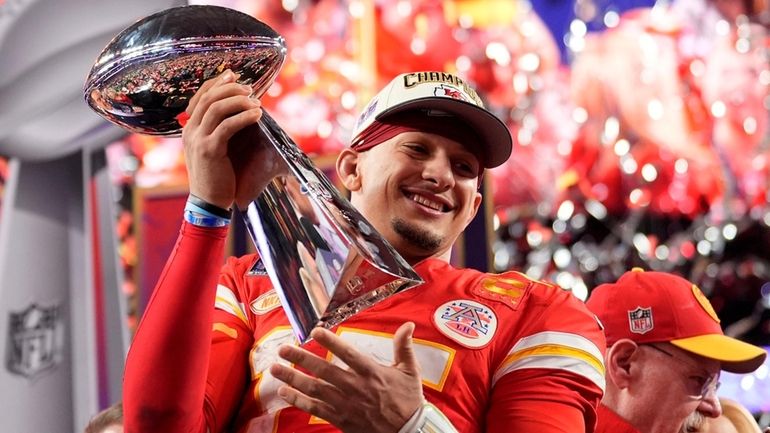 Kansas City Chiefs quarterback Patrick Mahomes celebrates with the trophy...