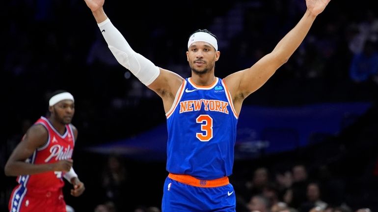 The Knicks' Josh Hart, right, reacts past the 76ers' Paul...