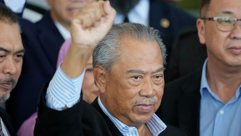 Malaysia's former Prime Minister Muhyiddin Yassin poses for media outside...