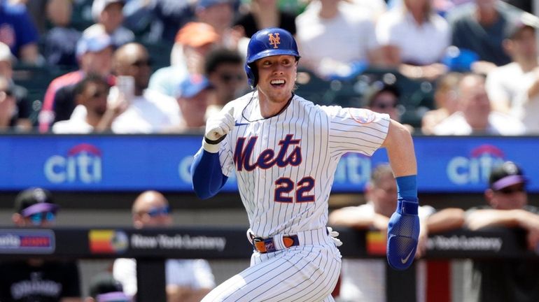 Brett Baty #22 of the Mets attempts to score a run...